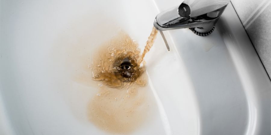 sink with brown water